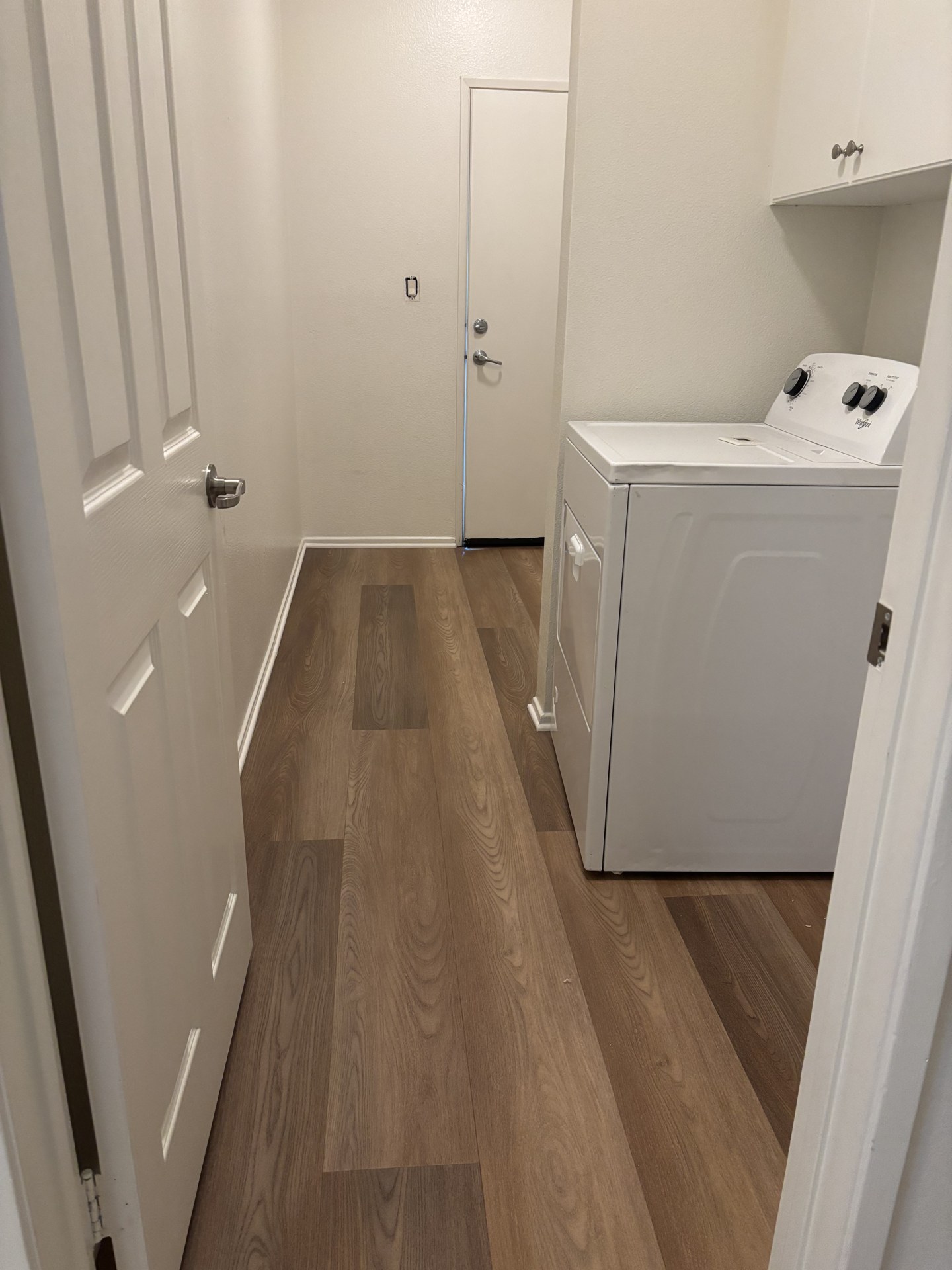 Matching brown plank flooring in the laundry room