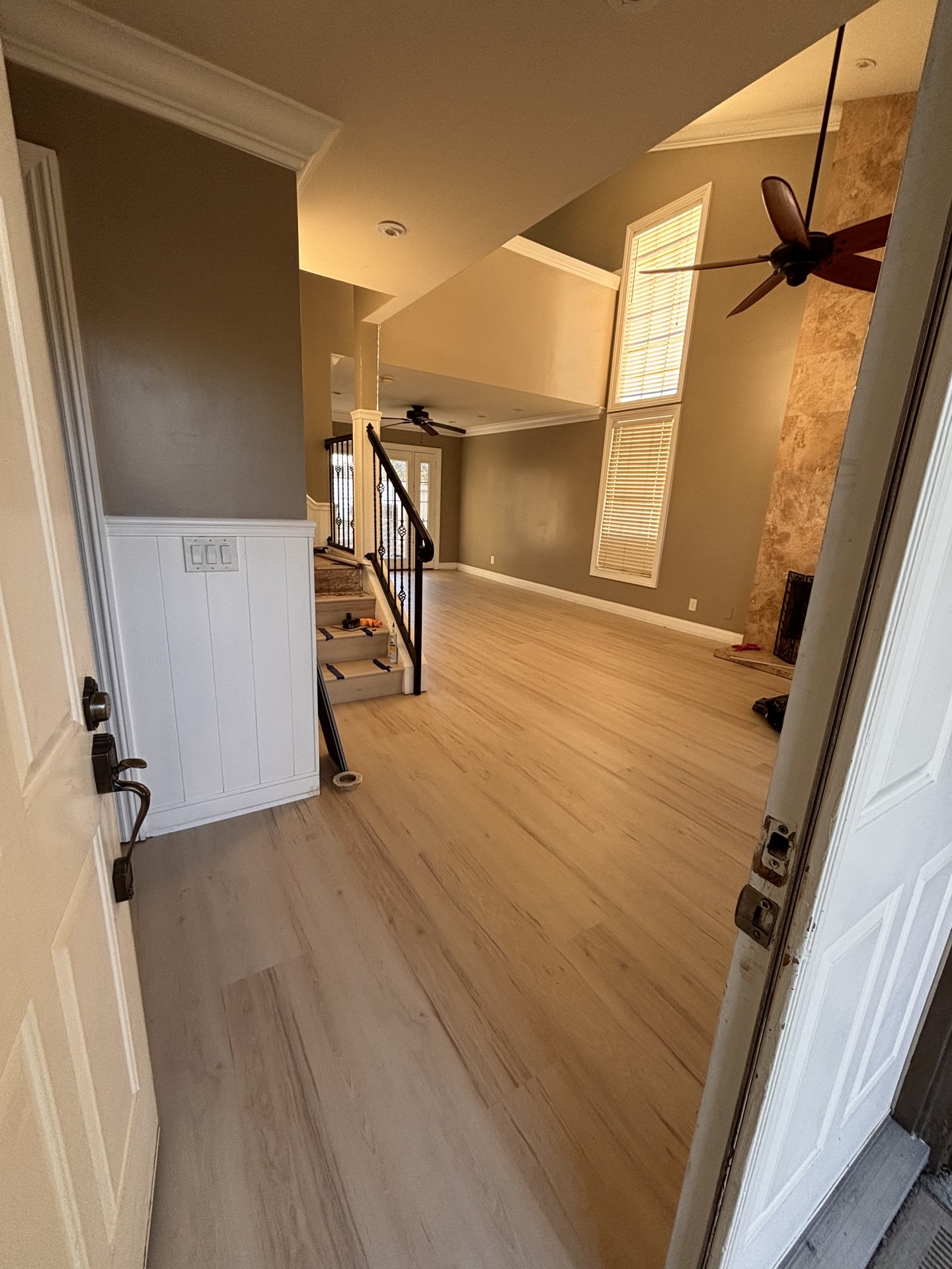 Light plank flooring continuing into the adjoining living area