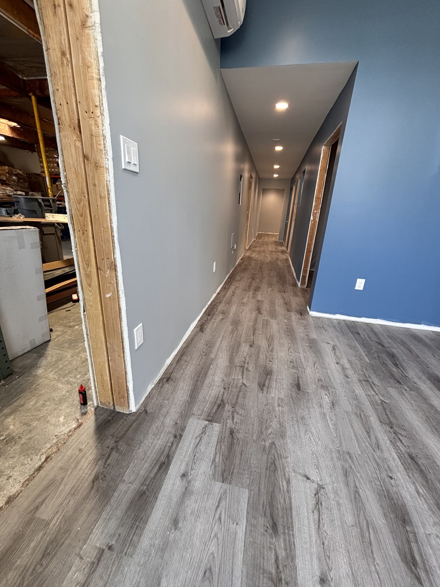 Matching gray plank flooring along the hallway