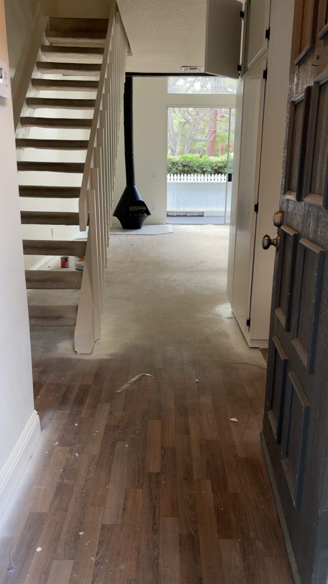 Original darker flooring in the same hallway beside the stairs