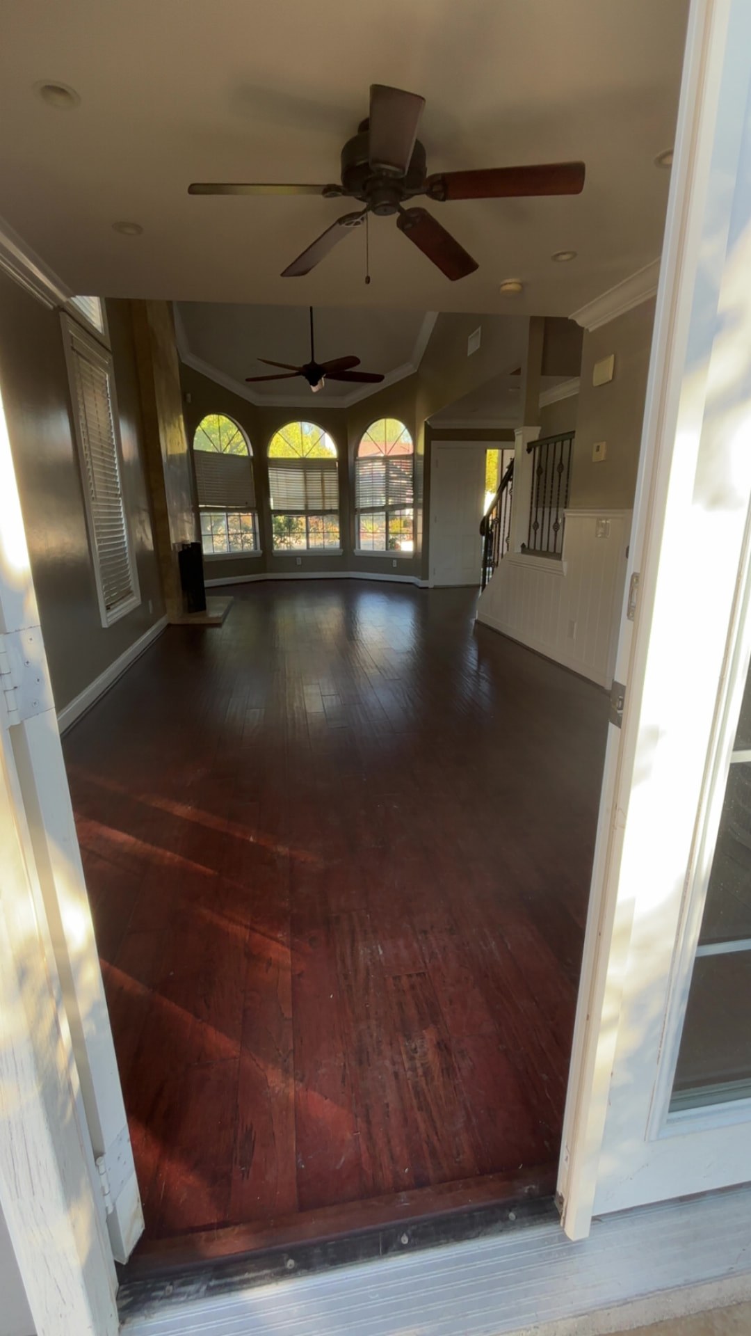 The same living space with its original dark flooring