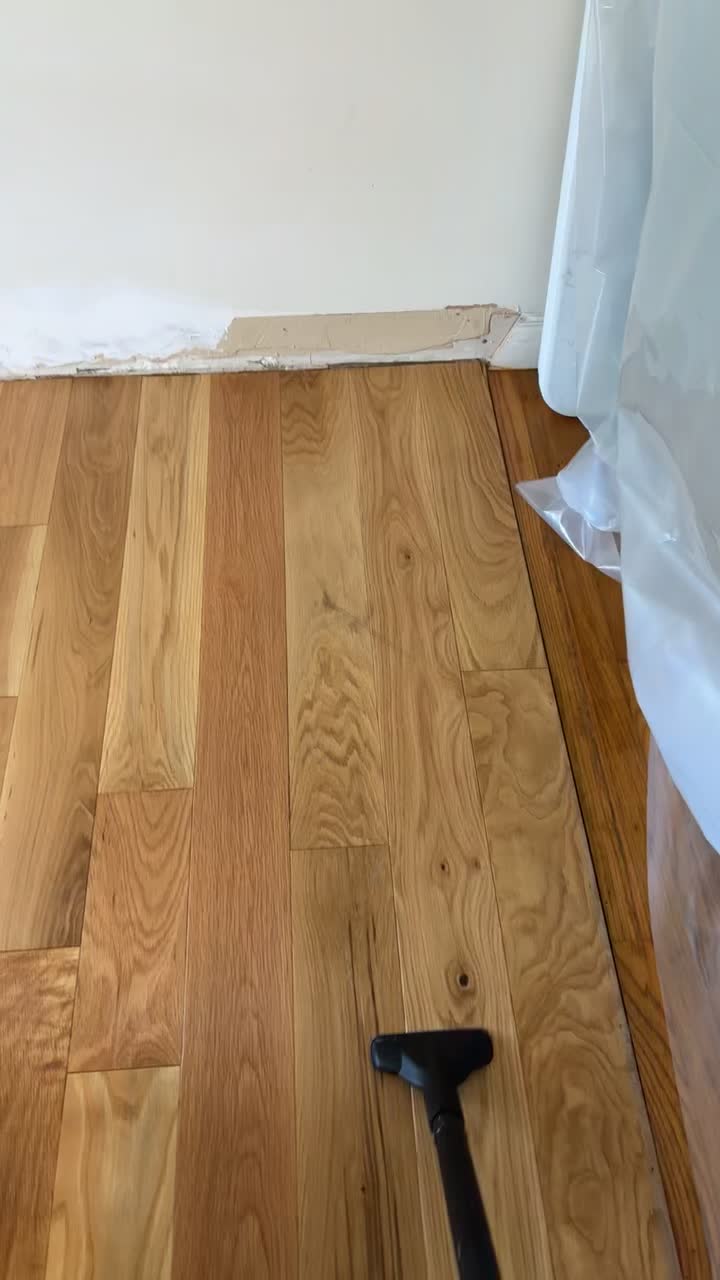 Close-up video of cleaning the warm wood flooring