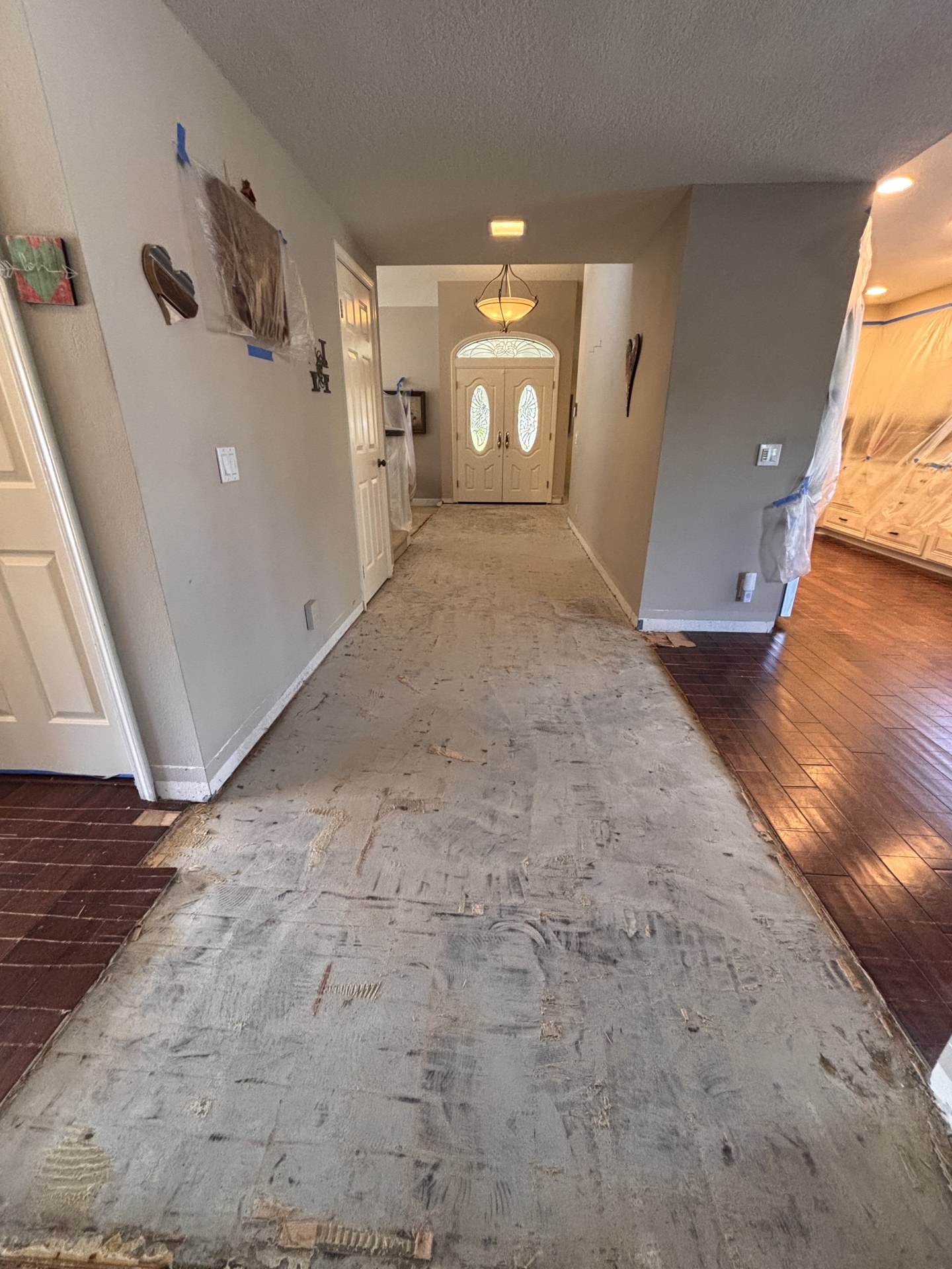 Entryway subfloor exposed during flooring preparation